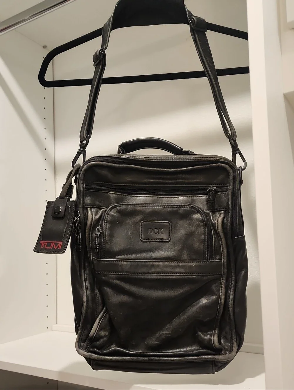 Tumi Black Leather Vertical Messenger Bag with Top Handle and Shoulder Strap